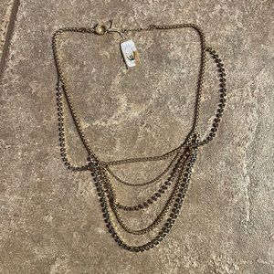 Women’s layered Fossil gold necklace